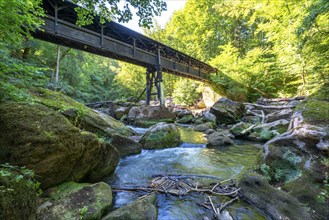 The Irrel Waterfalls, rapids in the lower reaches of the Prüm, covered wooden bridge for hikers,