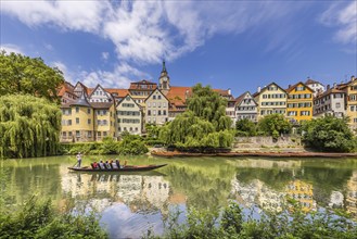 Neckarfront Tübingen with punt on the Neckar. Postcard motif with historic buildings, collegiate