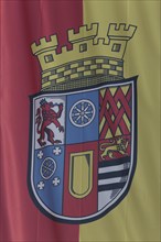 Flag with coat of arms at Oberstein Castle, yellow, red, blue, detail, Idar-Oberstein, Hunsrück,