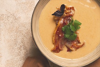 Pumpkin cream soup, curry, fried bacon, top view, no people