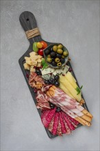 Appetizer, assortment, set, sausage, and cheese, on a wooden board, top view, no people