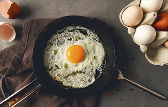 Breakfast, fried egg, in a cast-iron frying pan, top view, horizontal, no people