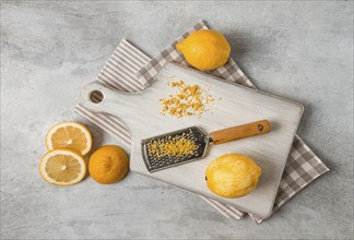 Grated lemon zest, on a cutting board, with a grater, top view, no people