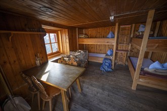 Small winter room in a mountain hut with beds and dining table, Ramolhaus, Ötztal Alps, Tyrol,