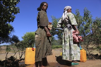 Amhara region, locals fetching water from a well, Ethiopia, Africa