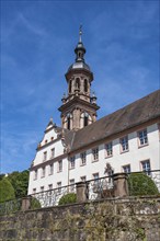 Former Benedictine abbey with the bell tower of the town church of St Mary, historical sight in the