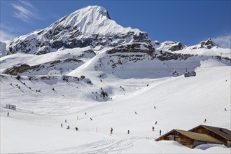 Skiing against the backdrop of the Bernese Alps in Grindelwald, Switzerland. The mountain in the