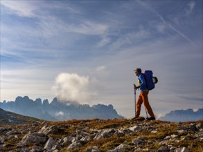 Mountaineer with view of rose garden, Schlern, Dolomites, South Tyrol, Italy, Europe