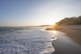 Sandy beach beach and sea at sunset, Playa Cocalito, coastal landscape, Pacific coast, Nicoya