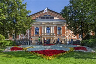 Flower border with the Richard Wagner Festival Theatre of the Bayreuth Festival on the Green Hill,