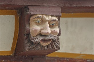 Wood carving with envious head symbolising envy, resentment, jealousy, grimace, allegory, allegory,