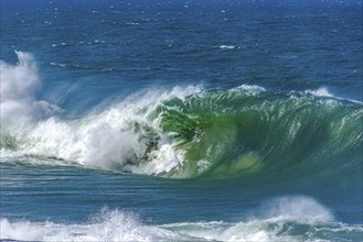 Big wave crashing hard onto the beach on a sunny day after a tropical storm, Ipanema Beach, Rio de