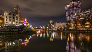 Lights reflected in the Danube Canal, on the left the Urania observatory, on the right illuminated