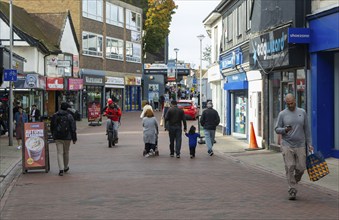 People shoppers walking along pedestrianised town centre street, Westgate Street, Ipswich, Suffolk,