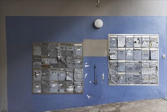 Doorbell sign, broken letterbox system on a dilapidated block of flats in Stuttgart,