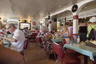 People eating inside the Ferry Cafe, Felixstowe Ferry, Suffolk, England, UK