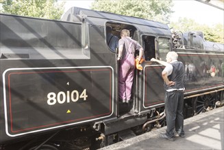 BR Standard Class 4 80104 steam locomotive train engine at platform of railway station, Swanage,