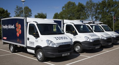 Parked Tesco home delivery vehicles advertised as offering a 'freshly clicked' service, UK