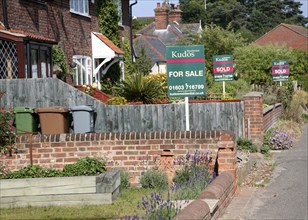 Estate agent signs and housing at Reedham, Norfolk, England, United Kingdom, Europe