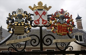 Ancient family coat of arms on railings at De Burcht historic site, Leiden, Netherlands with red