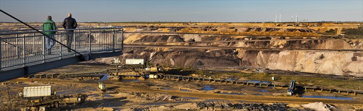 Two men on the Jackerath viewing platform look out over the Garzweiler open-cast lignite mine,