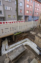 Construction site of a district heating house connection, pipes, insulated, are laid from a central