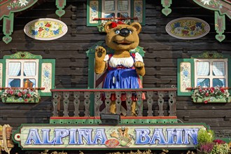 Mountain hut with teddy bear in traditional traditional costume, bear figurine, decoration of the