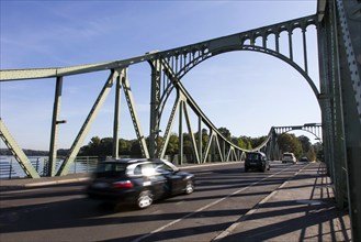 Cars drive over the Glienicke Bridge in Potsdam. The Glienicke Bridge today forms the city boundary