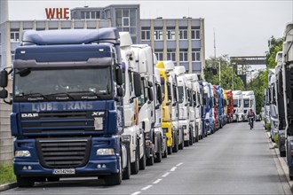 Truck tractors, exclusively from Eastern European countries, park in the harbour area, the canal