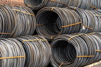 Steel wire, coils, waiting for further processing in the Rhine-Ruhr harbour in Mülheim an der Ruhr,