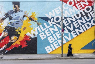 Large-format mural welcoming football fans to EURO 2024 at Dortmund Central Station, North