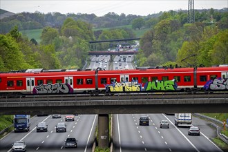 S-Bahn train crossing the motorway A3, traffic on 8 lanes, incl. the temporarily released hard