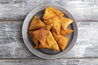 Nachos on a gray plate on a gray wooden background. Top view, close up