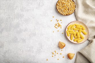 Jelly corn candies on gray concrete background and linen textile. top view, flat lay, copy space