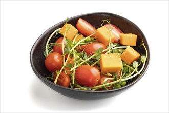 Vegetarian vegetable salad of tomatoes, pumpkin, microgreen pea sprouts isolated on white