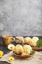 Traditional Tatar candy chak-chak made of dough and honey with cup of coffee on a black concrete