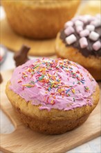 Homemade glazed and decorated easter pies with chocolate eggs and rabbits on a white concrete