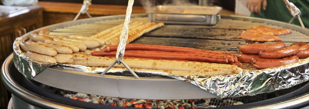 Sausages and steaks on the swing grill