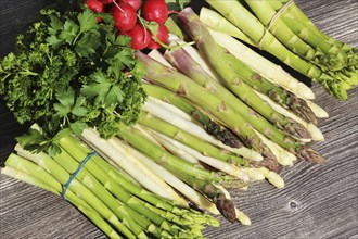 Green asparagus and white asparagus decorated on a rustic wooden table