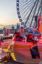 Deutz funfair on the Rhine, at Easter, funfair, break-dancer ride, Ferris wheel, Cologne Cathedral,