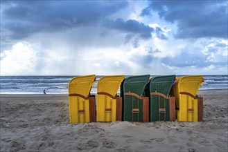 End of the season on the beach, dark storm clouds, choppy sea, autumn on the North Sea in North