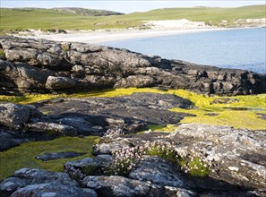 Rocky headland and sandy beach at Bagh a Deas, South Bay, Vatersay island, Barra, Outer Hebrides,