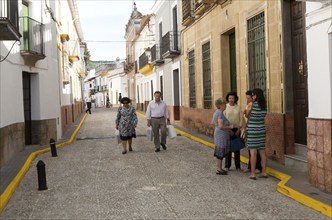 Group of women talking in the street, village of Alajar, Sierra de Aracena, Huelva province, Spain,