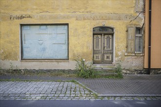 Symbolic photo on the subject of vacant shops in rural areas. A taped-up shop window in a vacant