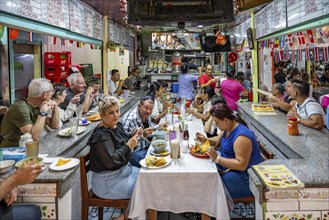 Visitors sitting at a table at a food stall, Mercado Central de San José, San José, Costa Rica,