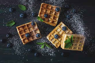 Viennese waffles with blueberries, on a dark background, breakfast, no people, selective focus