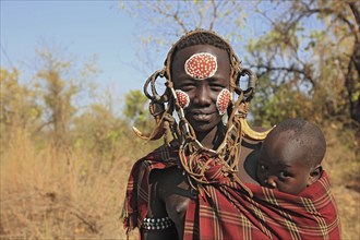 South Ethiopia, in Maco National Park, Mursi tribe, Mursi woman with baby, painted skin and