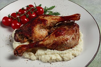 Fried duck shank, cauliflower puree, cherry tomatoes, homemade, no people