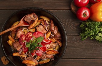 Ojakhuri, Traditional Georgian dish, fried potatoes with meat, in a clay frying pan, top view, no