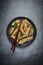 Japanese fried dumplings, gyoza, sesame seeds, top view, no people